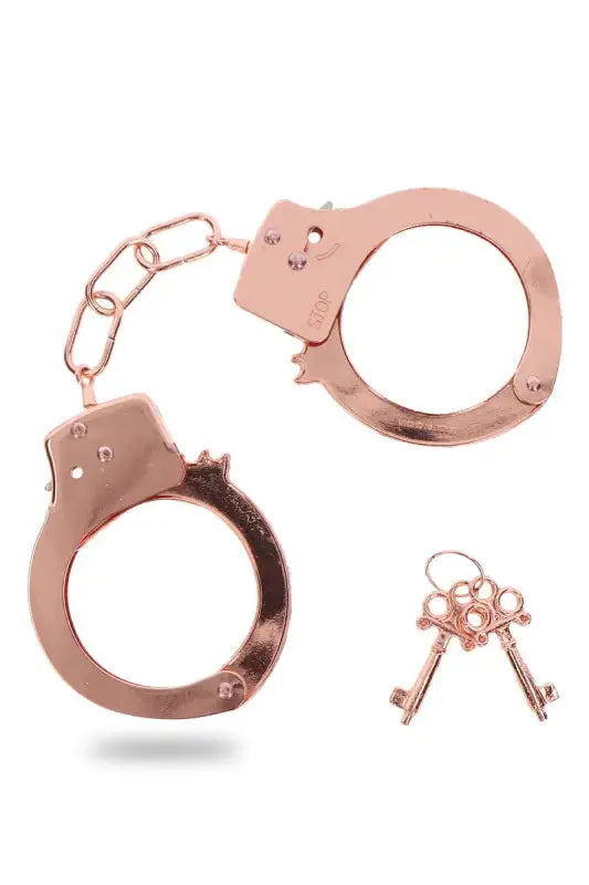 Menottes métal rose gold Toy Joy avec clés, parfaites pour des jeux de rôles sexy et séduisants.