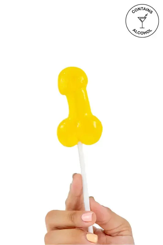 Sucette pénis alcoolisée goût pina colada tenue en main, idéale pour soirées amusantes